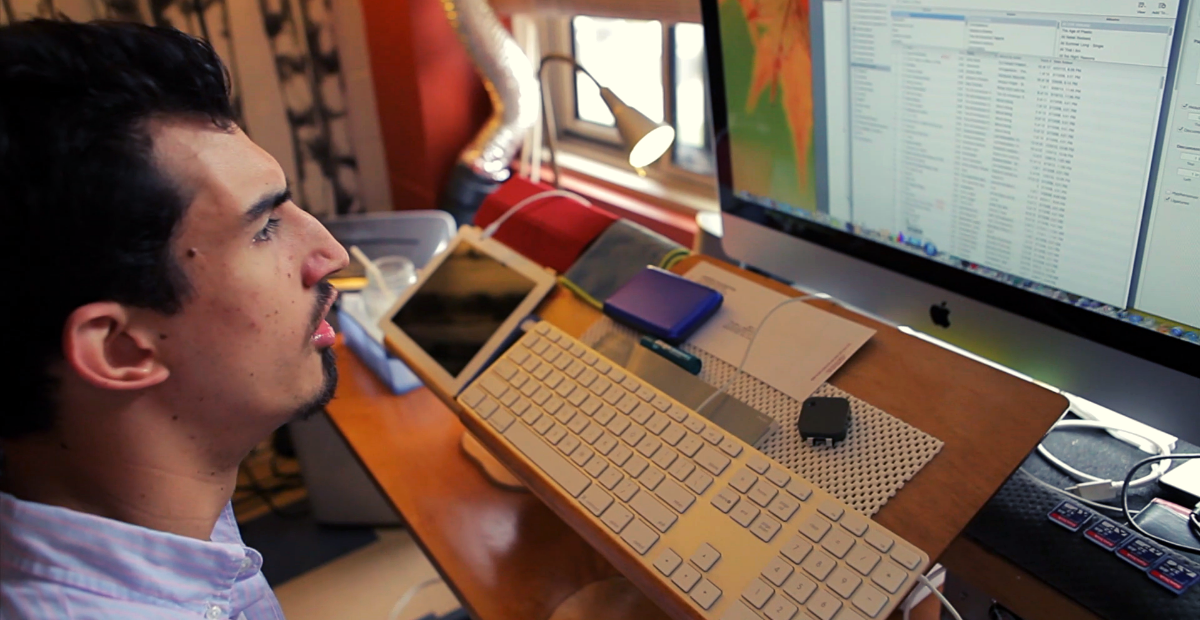 Man with cerebral palsy using assistive technology home office.