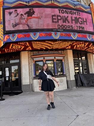 Rikki standing in front of a theater 