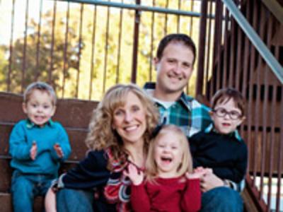 Fryar family photo, mom and dad with 3 young children, sitting on stairs