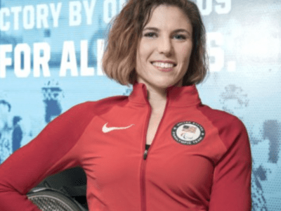  Amanda McGrory in a red athletic jumpsuit and an American pin