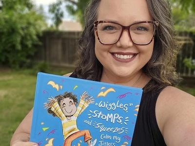 Lindsey Rowe Parker holding up her book