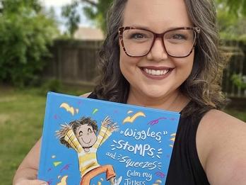 Lindsey Rowe Parker holding up her book