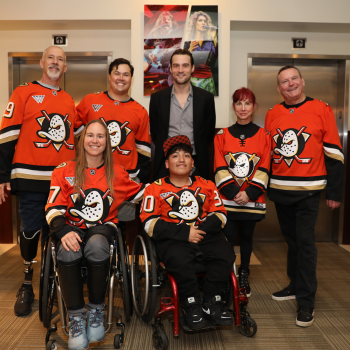 A group shot of six individuals wearing Anaheim Ducks jerseys.