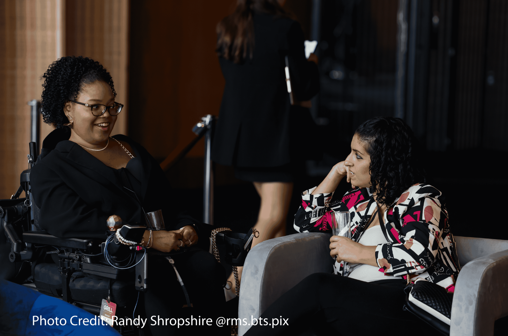 A photo of two women engaging in a conversation. 